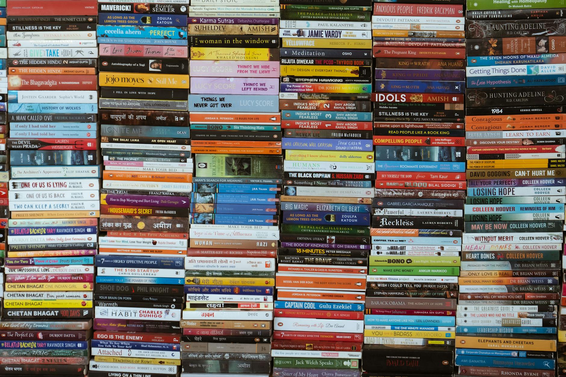 colorful array of books stacked in delhi market